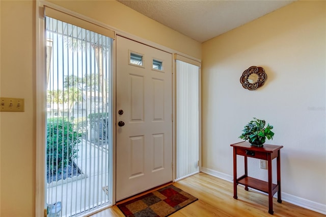 entryway with light wood-style floors and baseboards