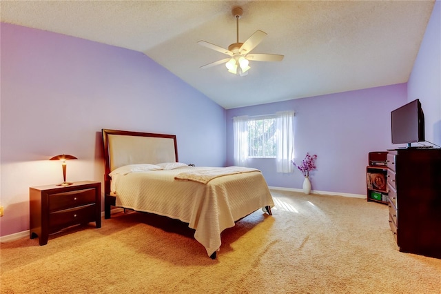 carpeted bedroom with a textured ceiling, a ceiling fan, baseboards, and vaulted ceiling