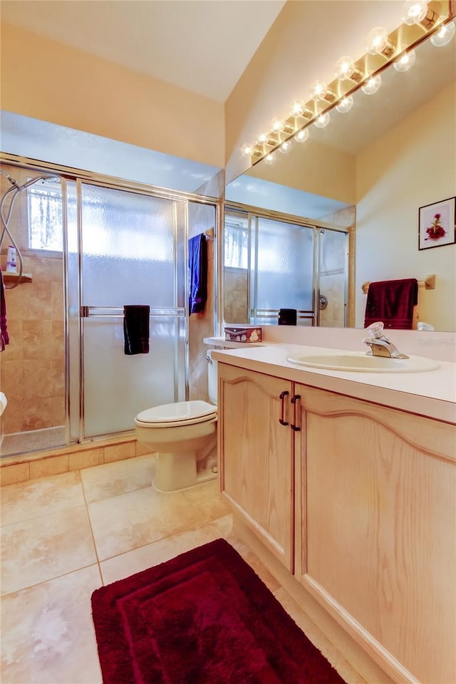 bathroom with a shower stall, vanity, and toilet