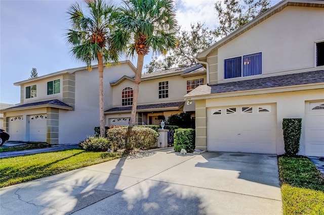 view of front of house featuring stucco siding, driveway, and a garage