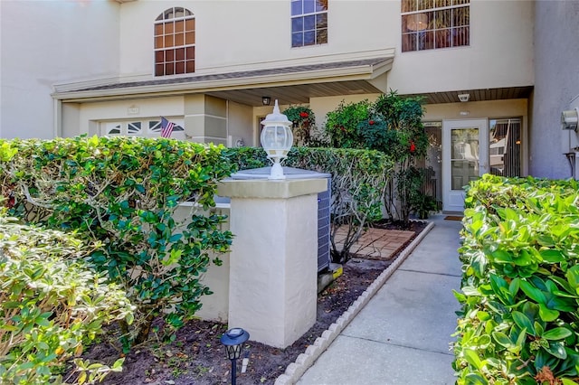 entrance to property featuring stucco siding