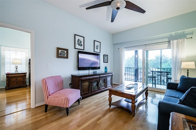 living room with ceiling fan and light wood-type flooring