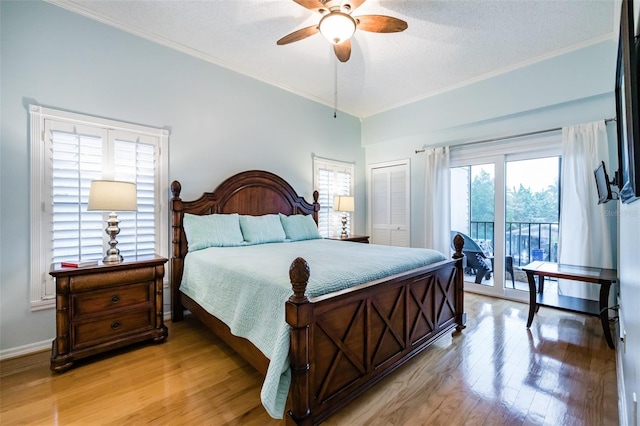 bedroom featuring crown molding, light hardwood / wood-style flooring, access to outside, a closet, and ceiling fan