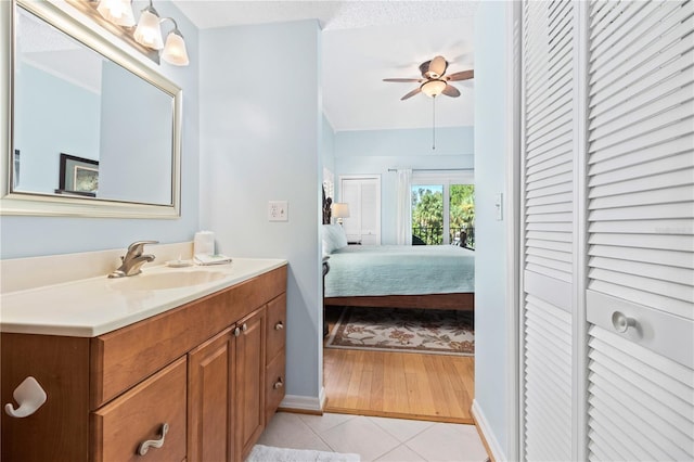 bathroom featuring tile patterned flooring, vanity, and ceiling fan