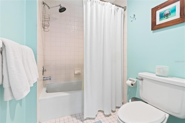 bathroom featuring shower / tub combo and toilet