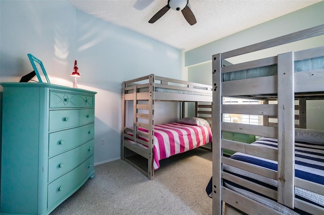 bedroom with ceiling fan and a textured ceiling