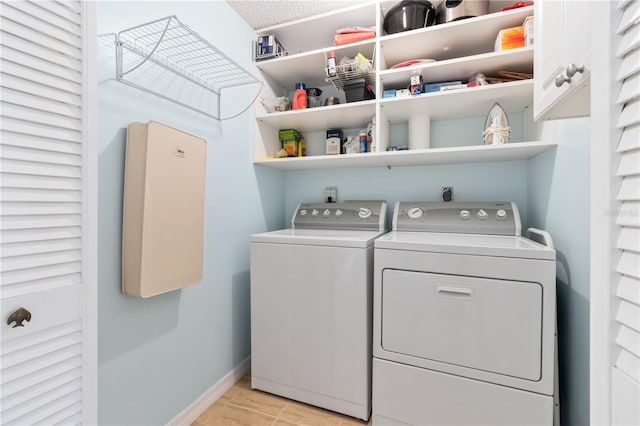 laundry room with cabinets and washer and clothes dryer