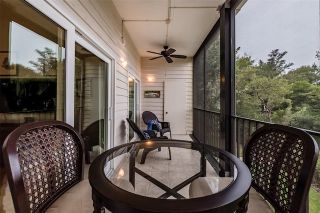 sunroom featuring ceiling fan