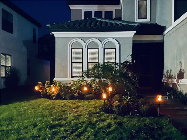 exterior entry at twilight with a yard