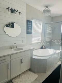 bathroom with plus walk in shower and vanity