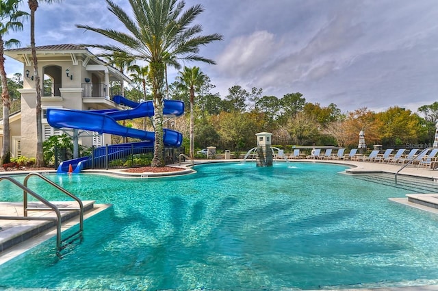 view of pool with a patio and a water slide