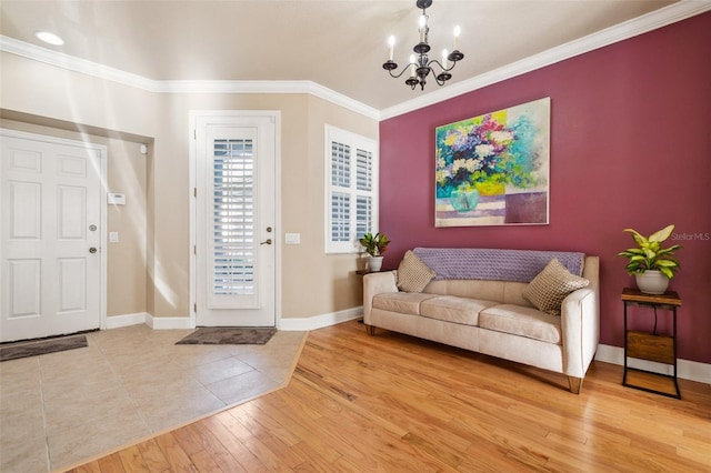 foyer entrance with crown molding, wood-type flooring, and a chandelier