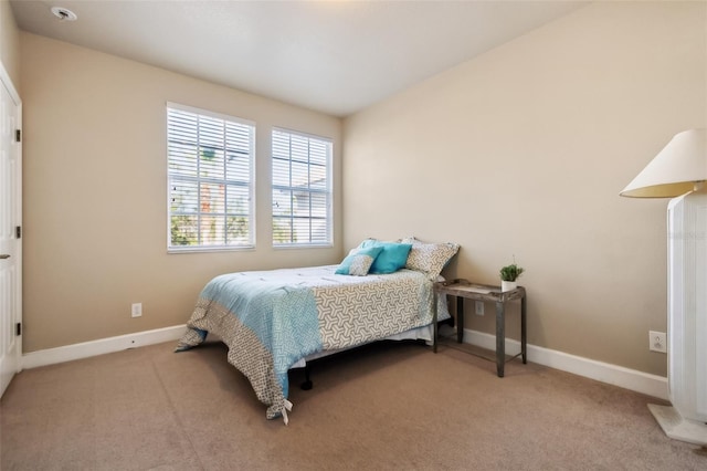 bedroom featuring light colored carpet