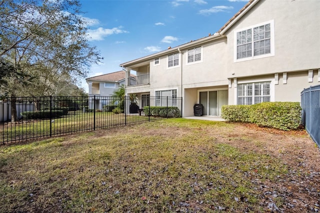 rear view of property featuring a yard