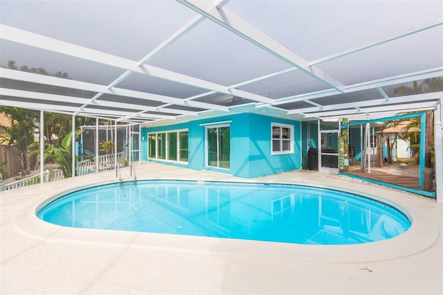 pool with a lanai and a patio area