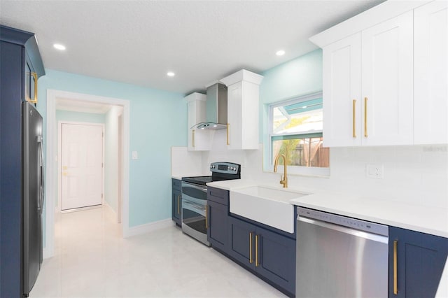 kitchen with white cabinetry, sink, decorative backsplash, stainless steel appliances, and wall chimney exhaust hood