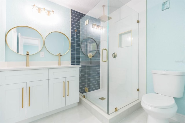 bathroom with vanity, toilet, and a shower with shower door