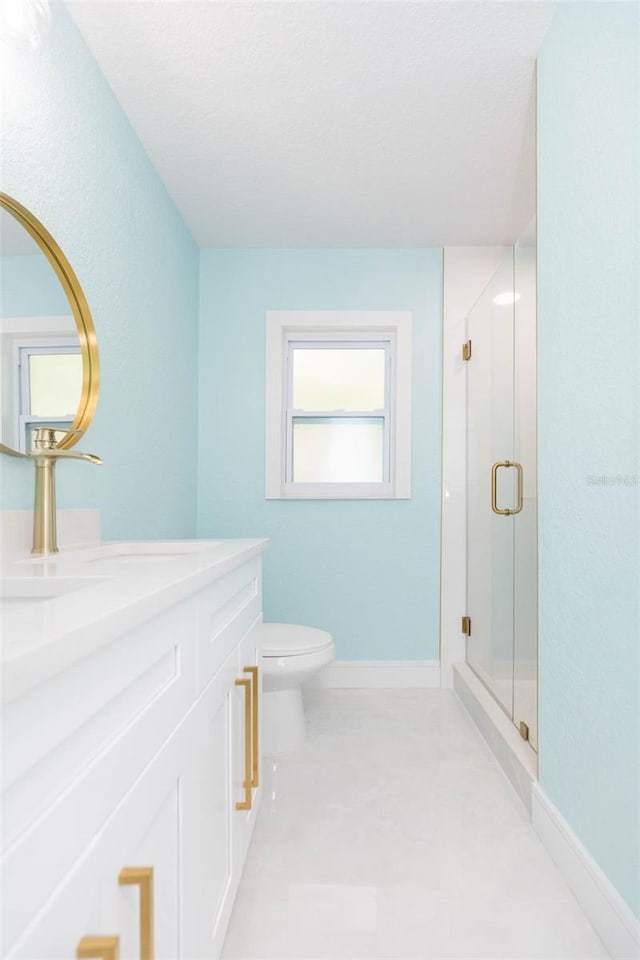 bathroom featuring an enclosed shower, vanity, tile patterned floors, and toilet