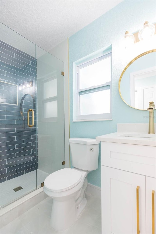 bathroom with tile patterned floors, toilet, a textured ceiling, vanity, and a shower with door