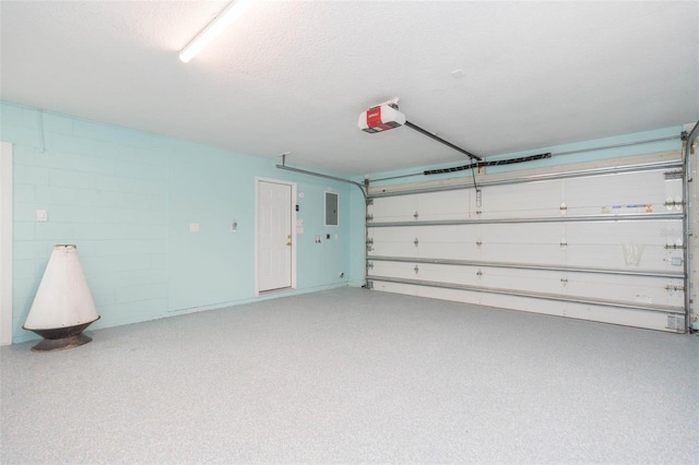 garage featuring a garage door opener and electric panel