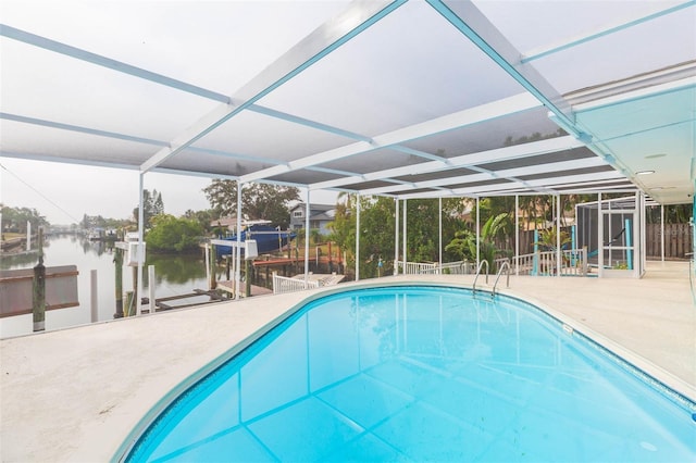 view of pool with a water view, a lanai, a patio area, and a boat dock