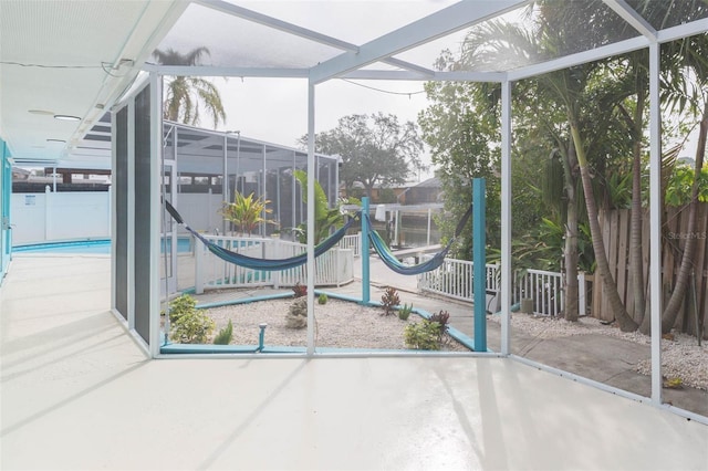 interior space featuring a lanai, a fenced in pool, and a patio area