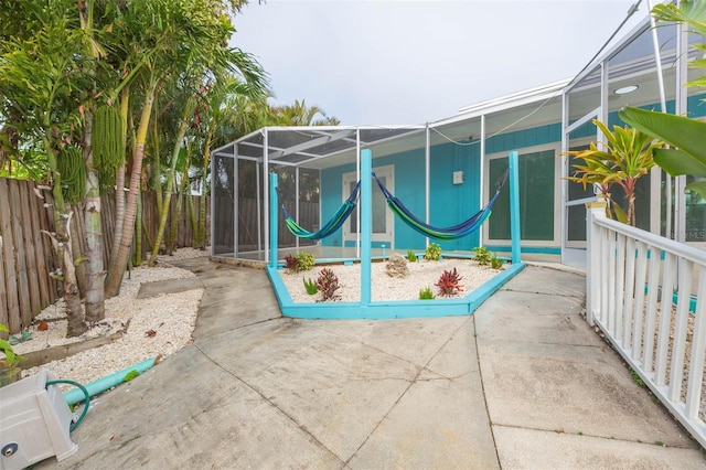 view of patio featuring a lanai