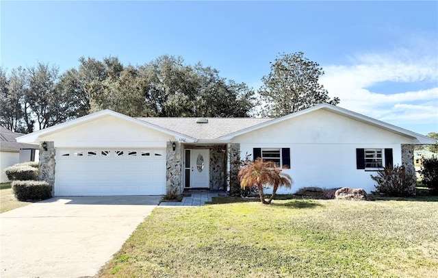 ranch-style home with a garage and a front lawn