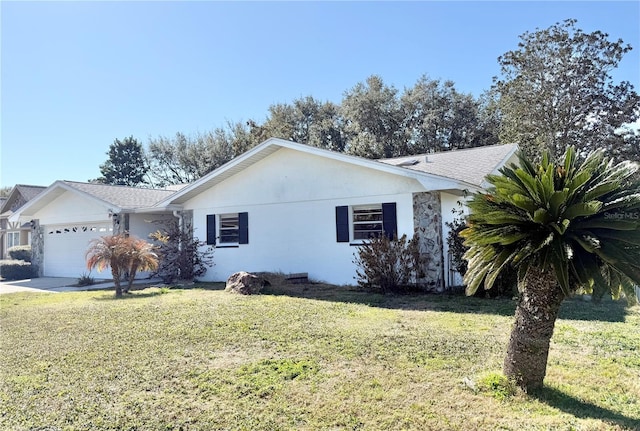 ranch-style house featuring a garage and a front yard