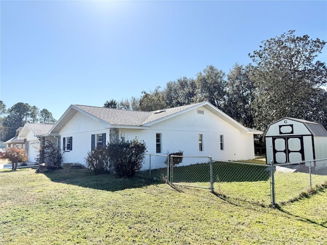 view of property exterior featuring a yard and a storage unit