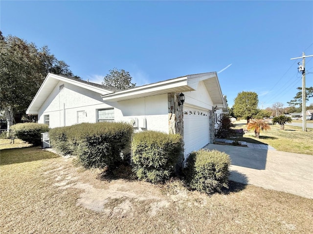 view of property exterior featuring a garage and a lawn