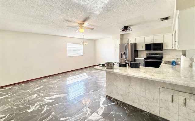 kitchen with sink, stainless steel fridge, range with electric cooktop, light stone counters, and white cabinets