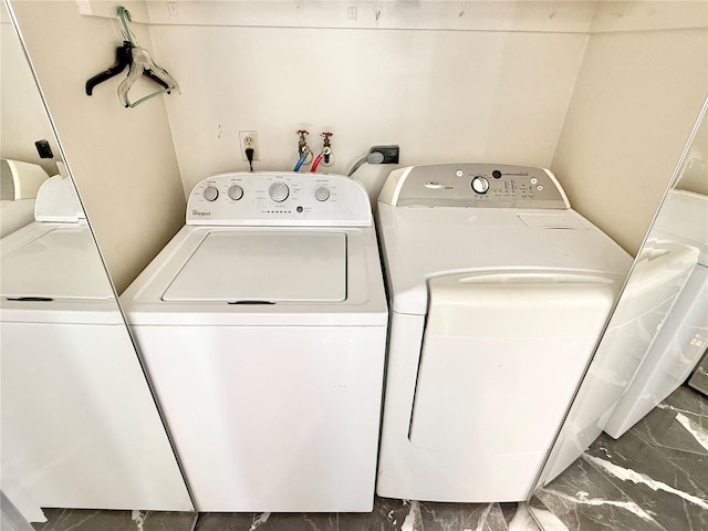 clothes washing area featuring washer and dryer