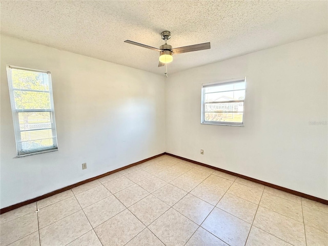 tiled empty room with a textured ceiling and ceiling fan