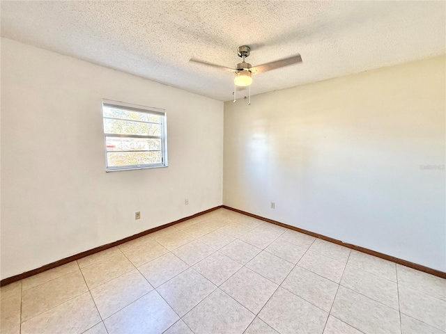 unfurnished room featuring light tile patterned floors, a textured ceiling, and ceiling fan