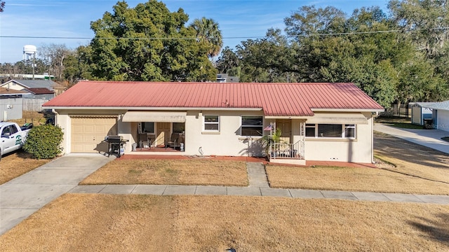 ranch-style home with a garage, a front lawn, and covered porch