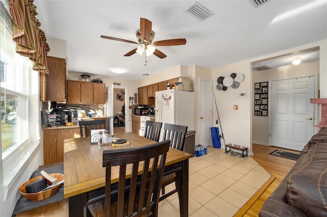 dining area featuring ceiling fan and light hardwood / wood-style floors