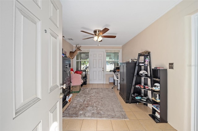 entryway with light tile patterned flooring and ceiling fan