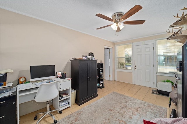 office featuring light tile patterned flooring, ceiling fan, crown molding, and a textured ceiling