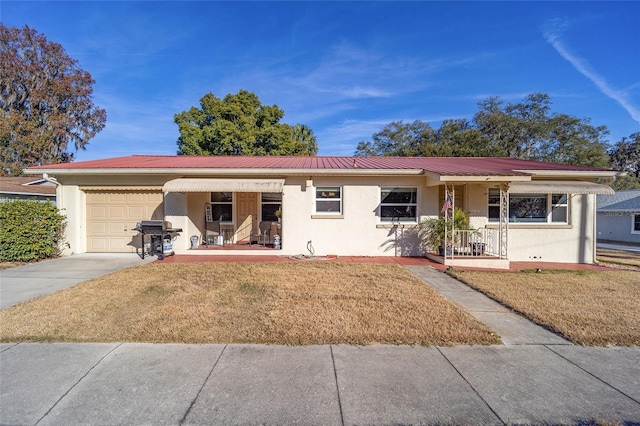 ranch-style house with a garage, covered porch, and a front lawn