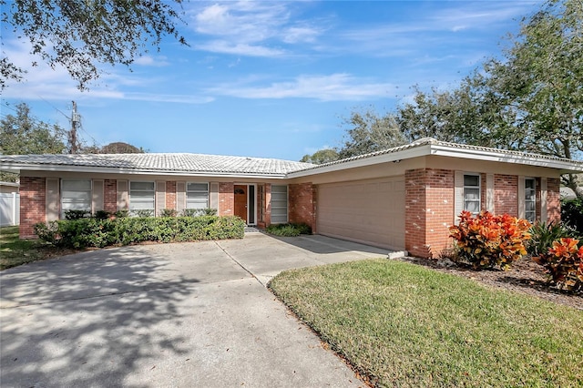 ranch-style house featuring a garage and a front yard