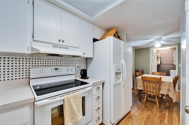 kitchen featuring white cabinetry, decorative backsplash, white appliances, ceiling fan, and light wood-type flooring