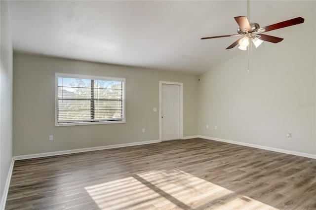 unfurnished room with hardwood / wood-style floors, vaulted ceiling, and ceiling fan