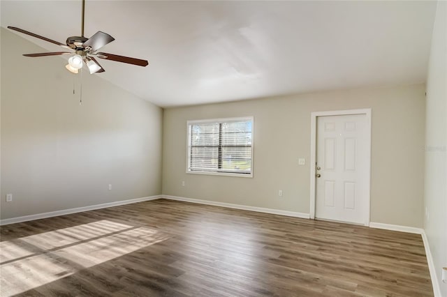 unfurnished room featuring dark wood-type flooring, ceiling fan, and vaulted ceiling