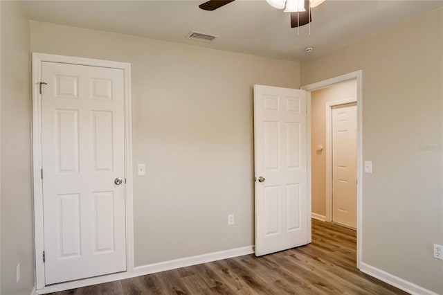 unfurnished bedroom featuring wood-type flooring and ceiling fan