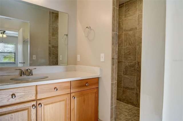 bathroom with vanity and a tile shower