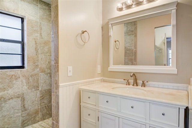 bathroom featuring vanity and tiled shower