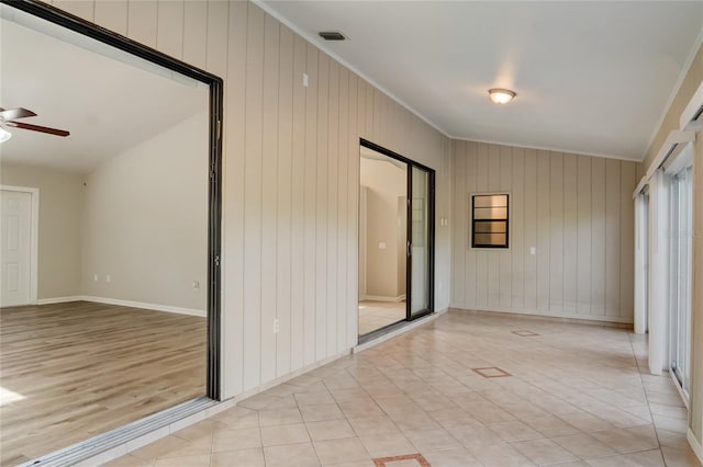 spare room with crown molding, light tile patterned floors, and ceiling fan