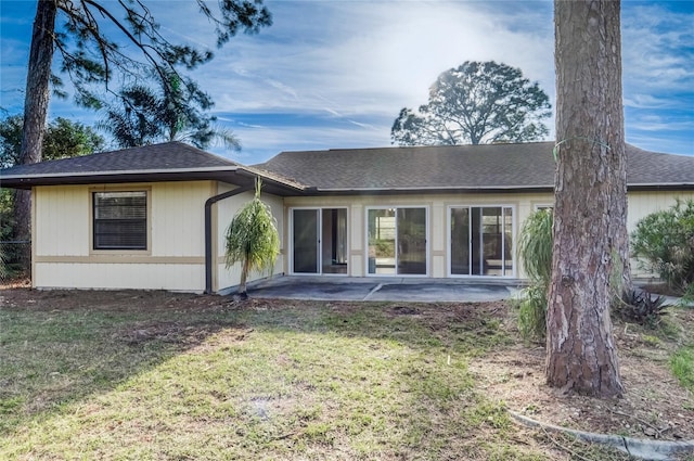 rear view of property with a yard and a patio area