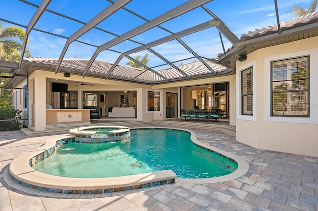 view of swimming pool featuring a patio, an in ground hot tub, and glass enclosure